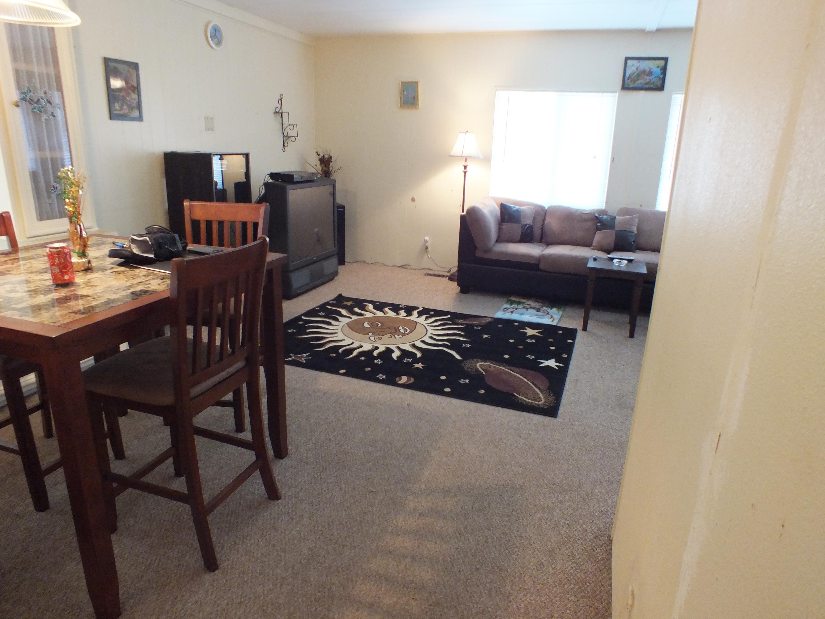 7725 Happy Valley Road, Unit DELUXE Anderson, CA 96007 - Photo 15 of 29 a living room with furniture and a flat screen tv