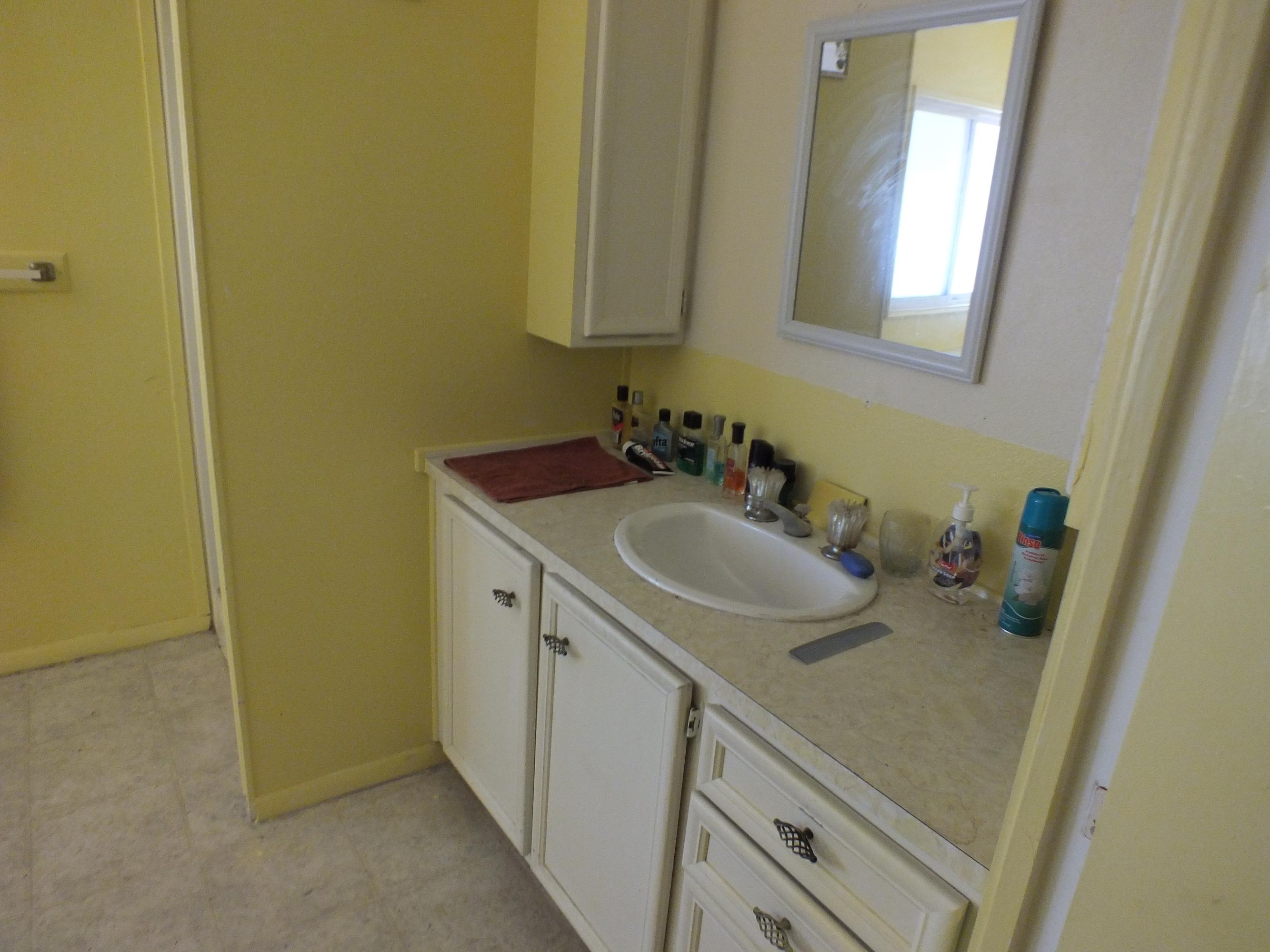 7725 Happy Valley Road, Unit DELUXE Anderson, CA 96007 - Photo 24 of 29 a bathroom with a sink and a mirror