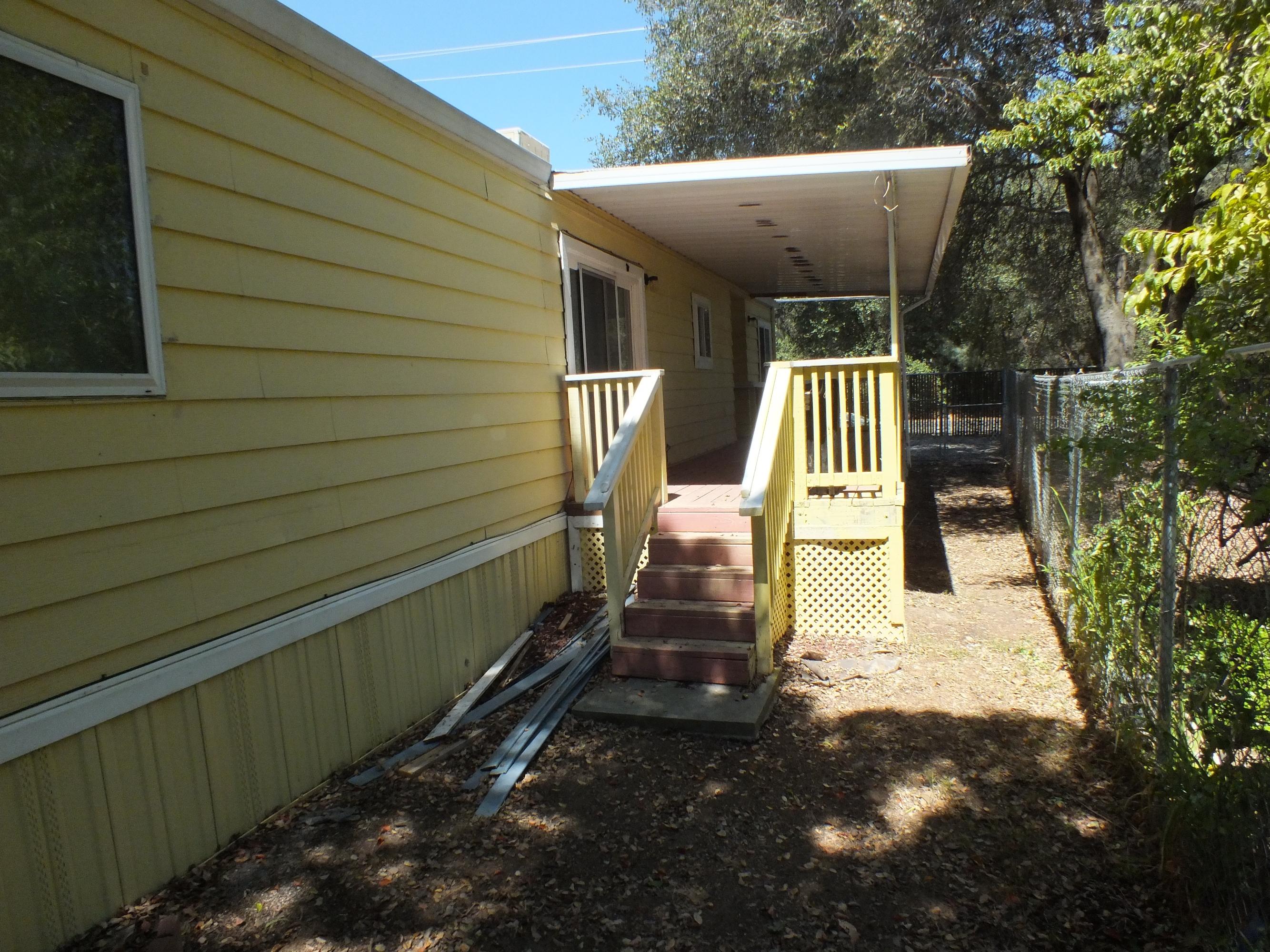7725 Happy Valley Road, Unit DELUXE Anderson, CA 96007 - Photo 6 of 29 a view of house with backyard and furniture