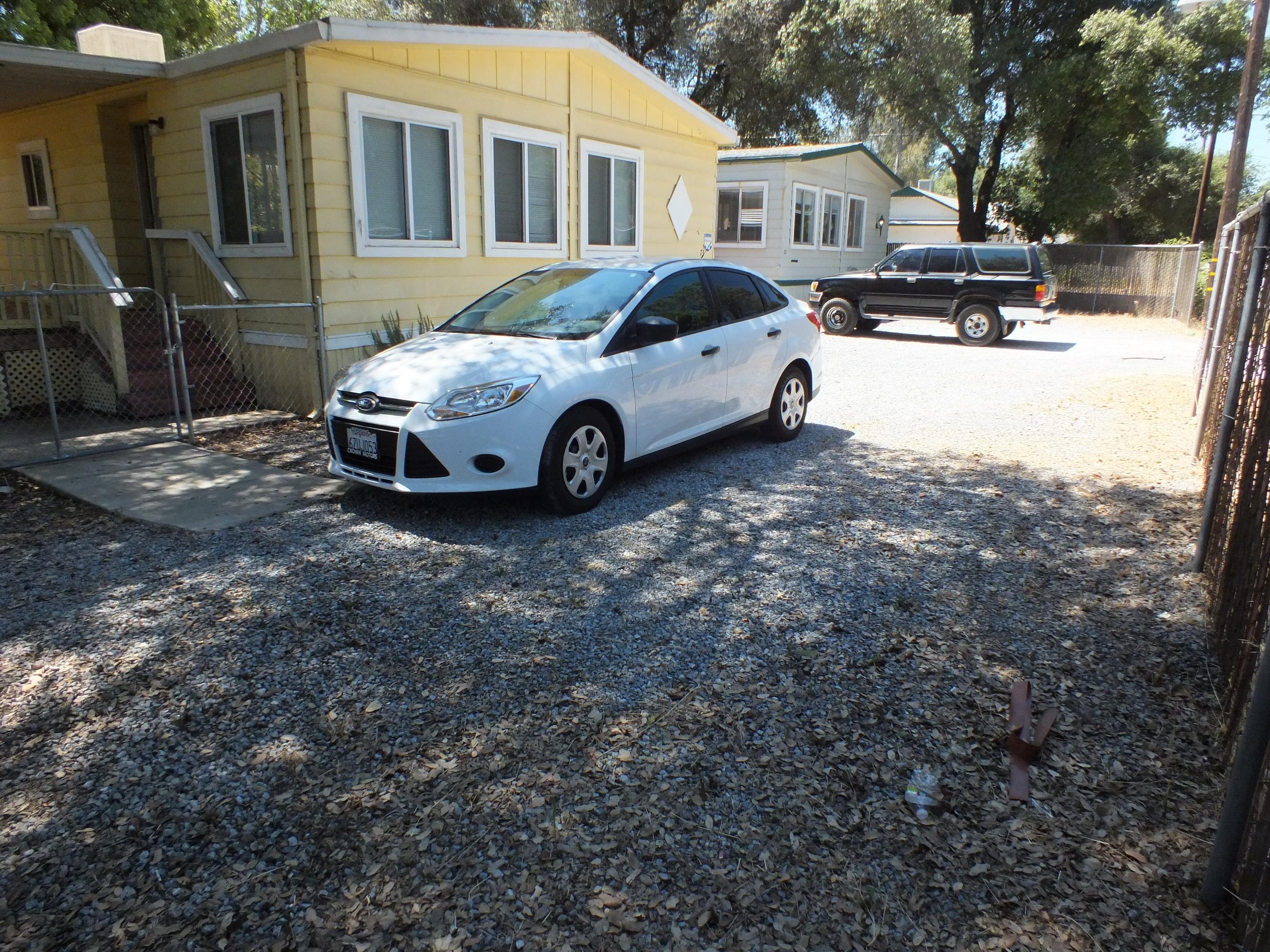 7725 Happy Valley Road, Unit DELUXE Anderson, CA 96007 - Photo 9 of 29 a car parked in front of a house