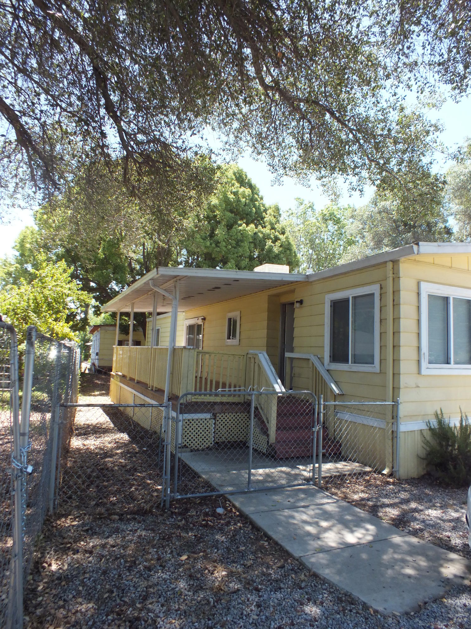 7725 Happy Valley Road, Unit DELUXE Anderson, CA 96007 - Photo 10 of 29 a view of a house with a yard and large tree