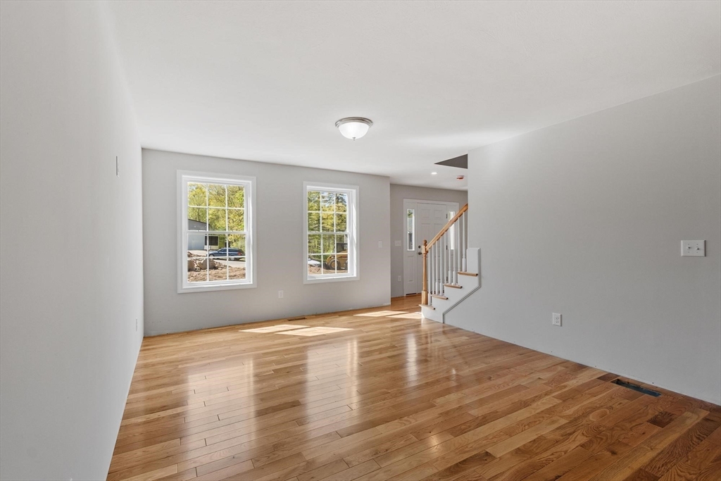 22 Benoit Avenue Pelham, NH 03076 - Photo 23 of 42 a view of empty room with wooden floor and fan