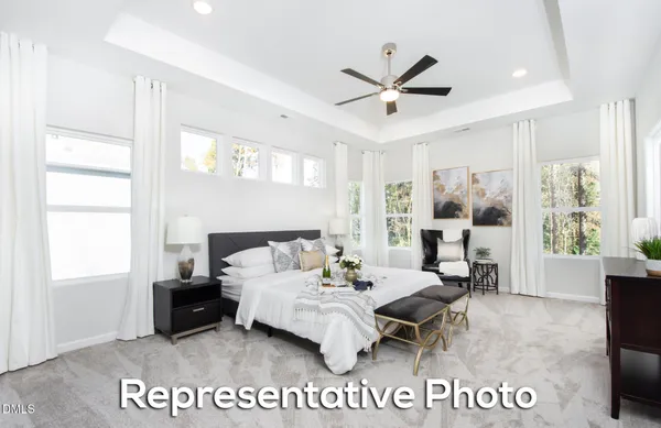 a bedroom with a bed a chandelier and a window