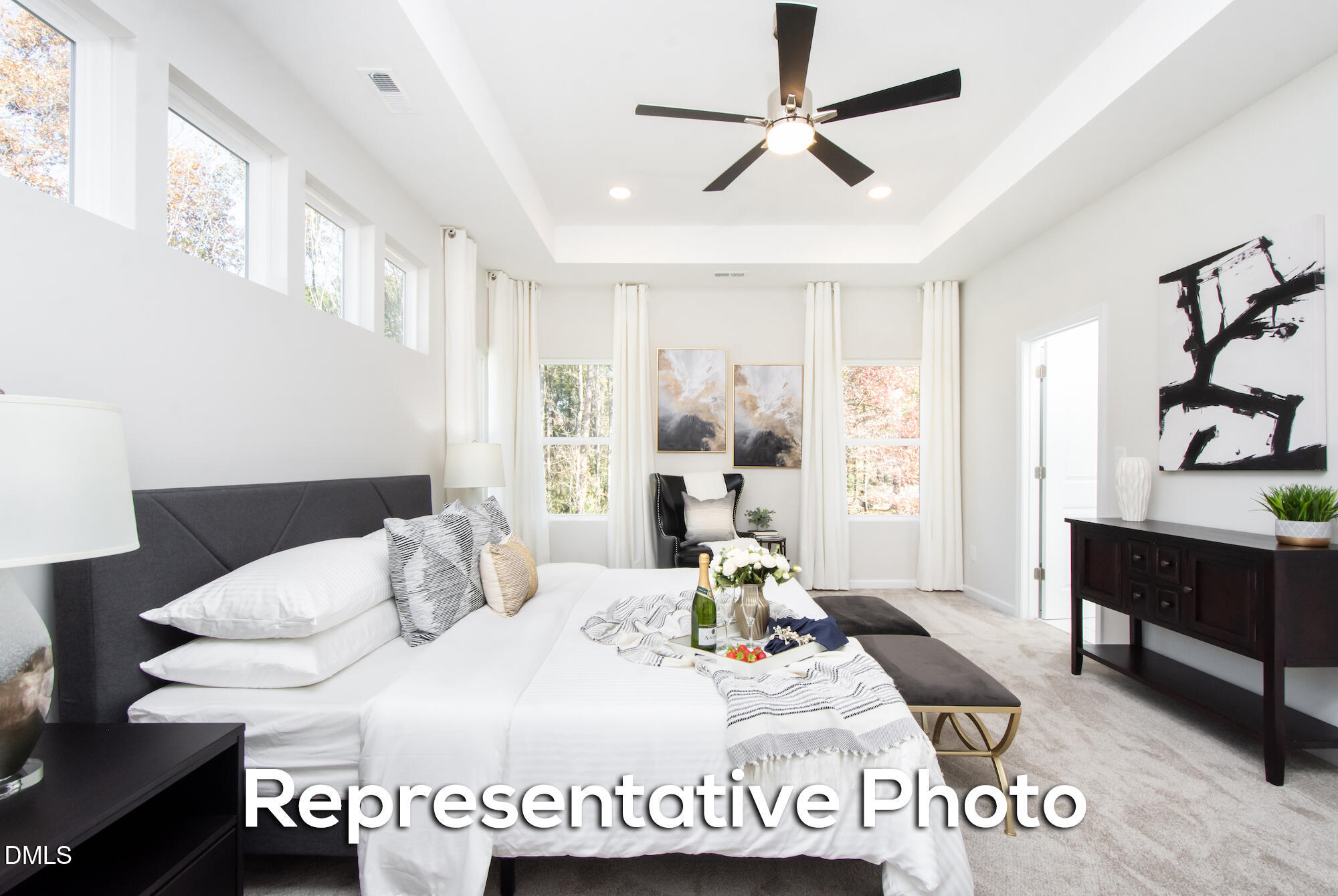 29 H River Meadow Spring Hope, NC 27882 - Photo 15 of 20 a bedroom with a bed a chandelier and a window