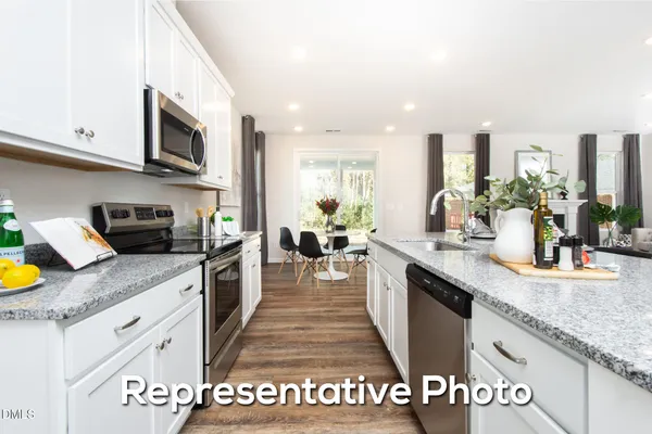 a large kitchen with granite countertop lots of counter top space
