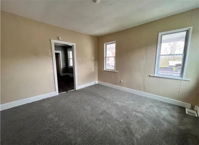 a view of an empty room with windows