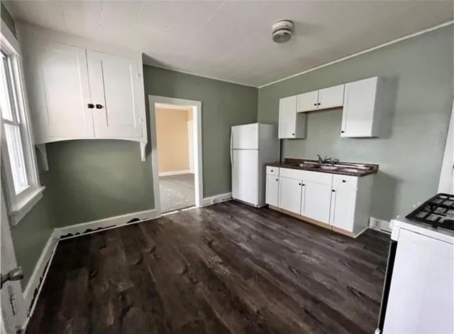 a kitchen with a sink and a stove top oven