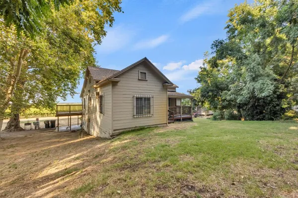 a view of a dirt road and a building