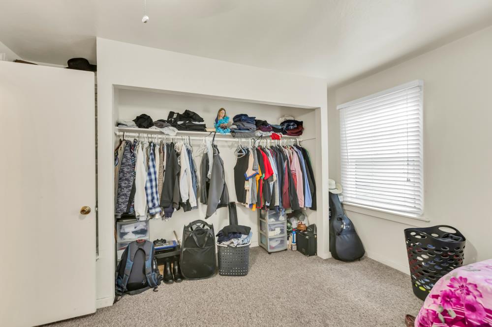 53140 South River Road Clarksburg, CA 95612 - Photo 21 of 66 a view of walk in closet with clothes and shoes