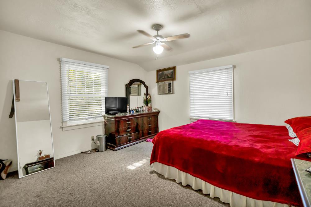 53140 South River Road Clarksburg, CA 95612 - Photo 22 of 66 a bedroom with a bed and a chandelier