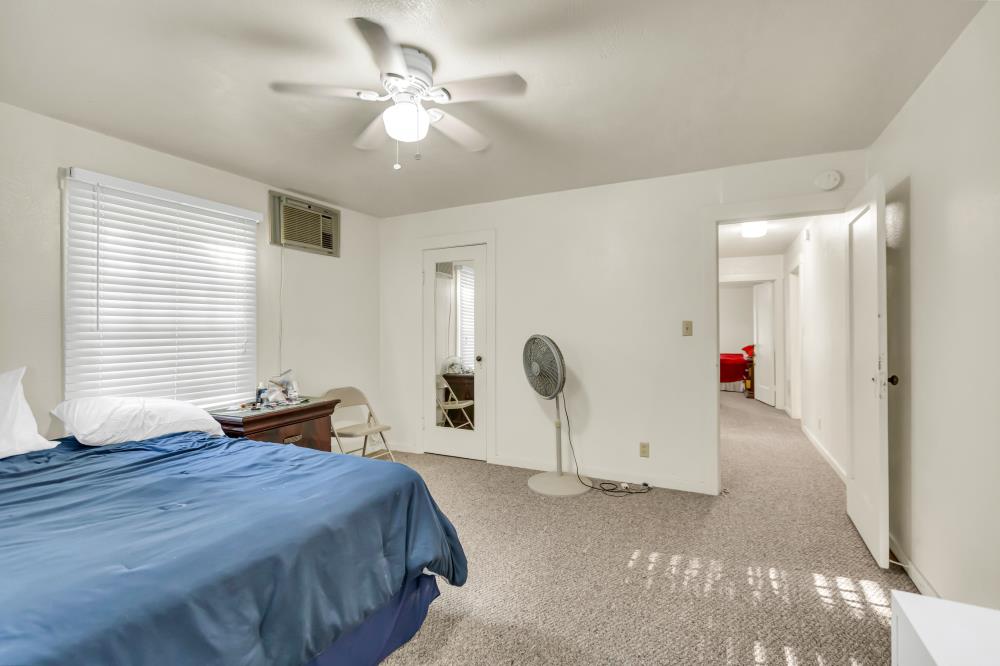 53140 South River Road Clarksburg, CA 95612 - Photo 28 of 66 a bedroom with a bed and a chandelier
