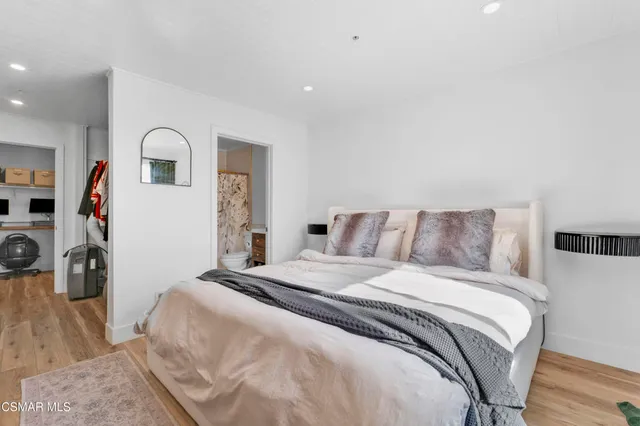 a bedroom with a bed and a walk in closet