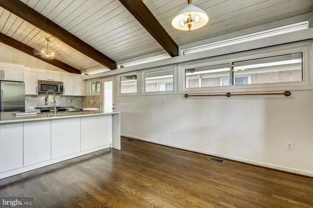 a kitchen with a refrigerator and a stove top oven