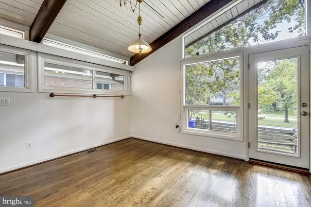 a view of a room with wooden floor and walls