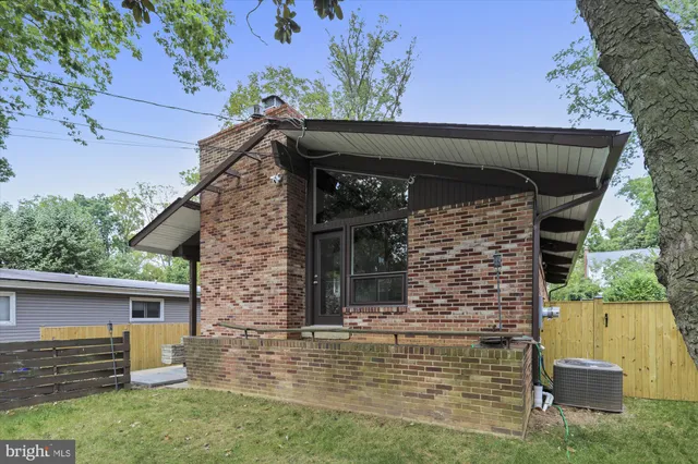front view of a house with a brick wall