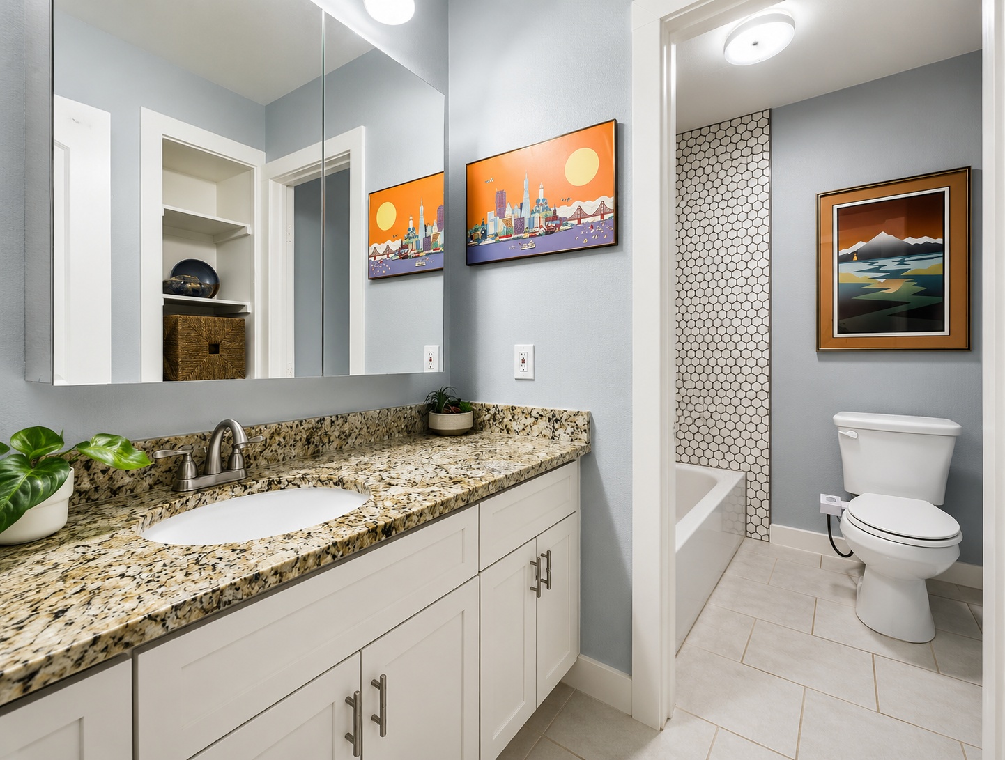 6211 Manor Road, Unit 105 Austin, TX 78723 - Photo 12 of 18 A generous-sized bathroom featuring a granite countertop vanity with good storage and hexagon tiled shower and recessed niche.
