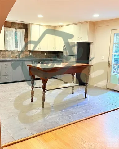 a living room with table and chairs