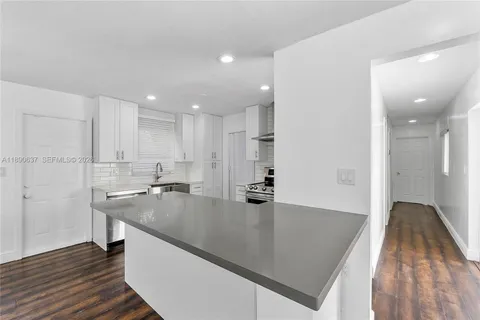 a kitchen with stainless steel appliances sink and stove top oven