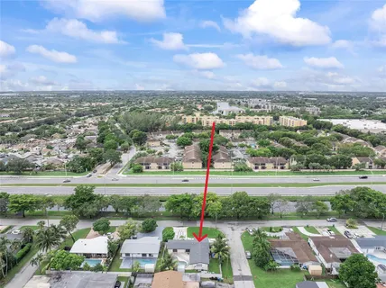 an aerial view of a house with a big yard