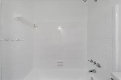 a view of wooden floor and chandelier fan in a room