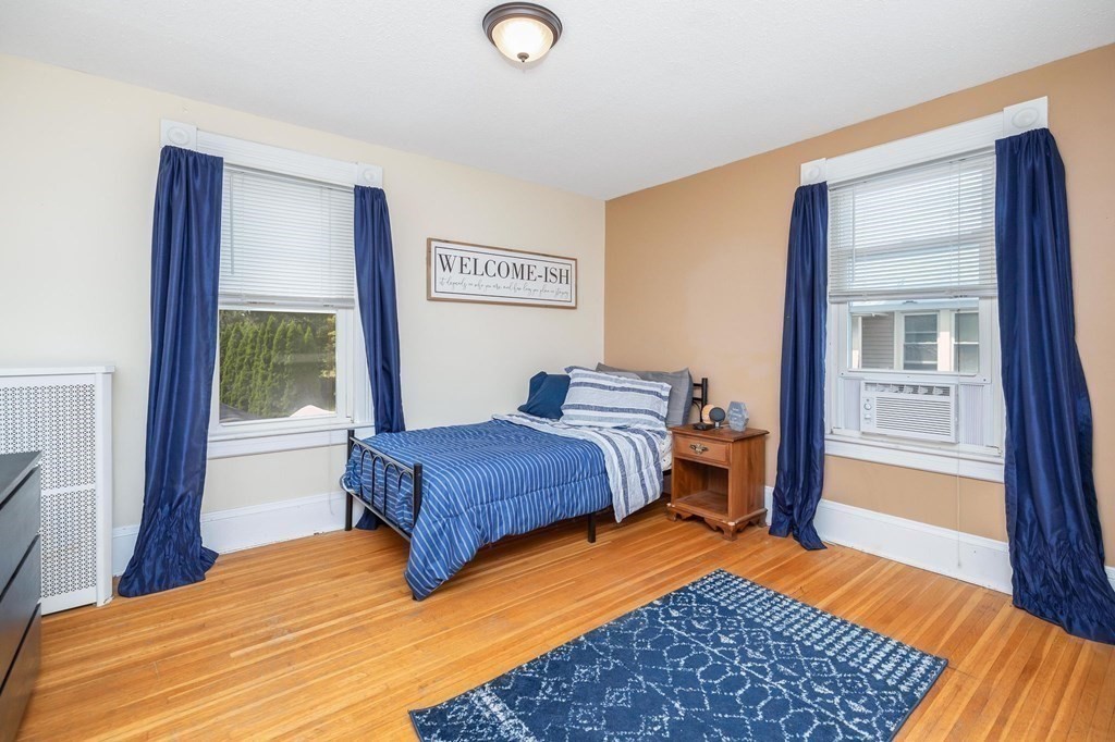 105 Pine Street West Springfield, MA 01089 - Photo 23 of 35 a bedroom with a bed and wooden floor
