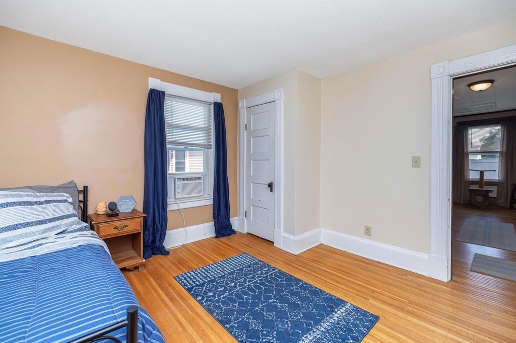 105 Pine Street West Springfield, MA 01089 - Photo 25 of 35 a bedroom with a bed and wooden floor