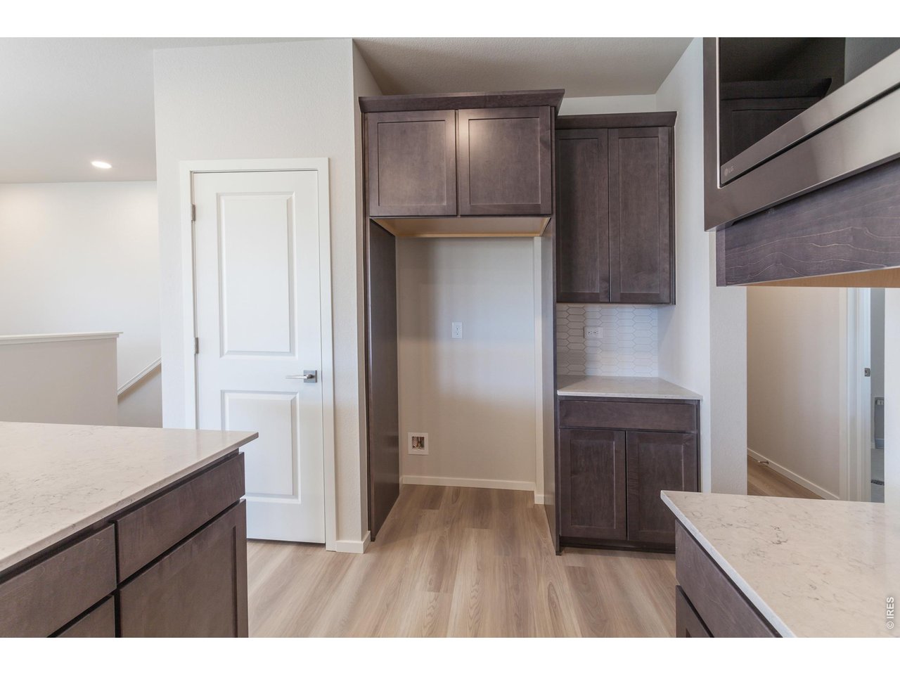 792 Chatter Road Windsor, CO 80550 - Photo 20 of 49 a kitchen area with granite countertop a refrigerator and a stove