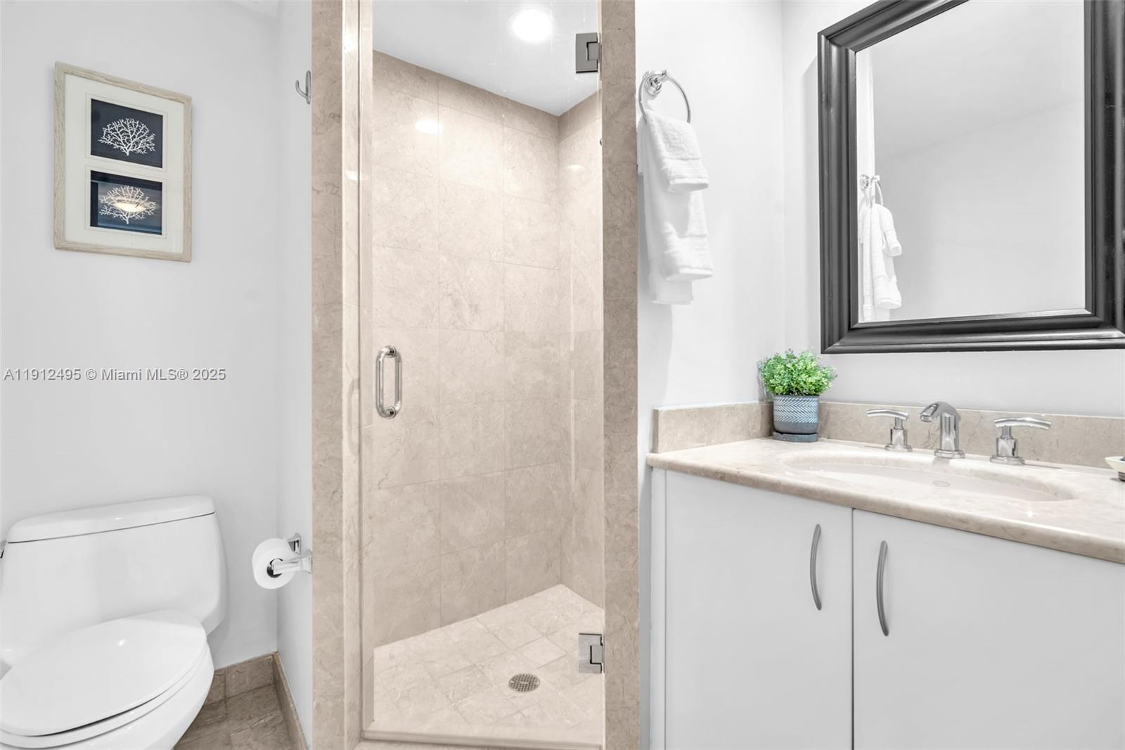 1331 Brickell Bay Drive, Unit 3609 Miami, FL 33131 - Photo 15 of 35 a bathroom with a granite countertop sink toilet and shower