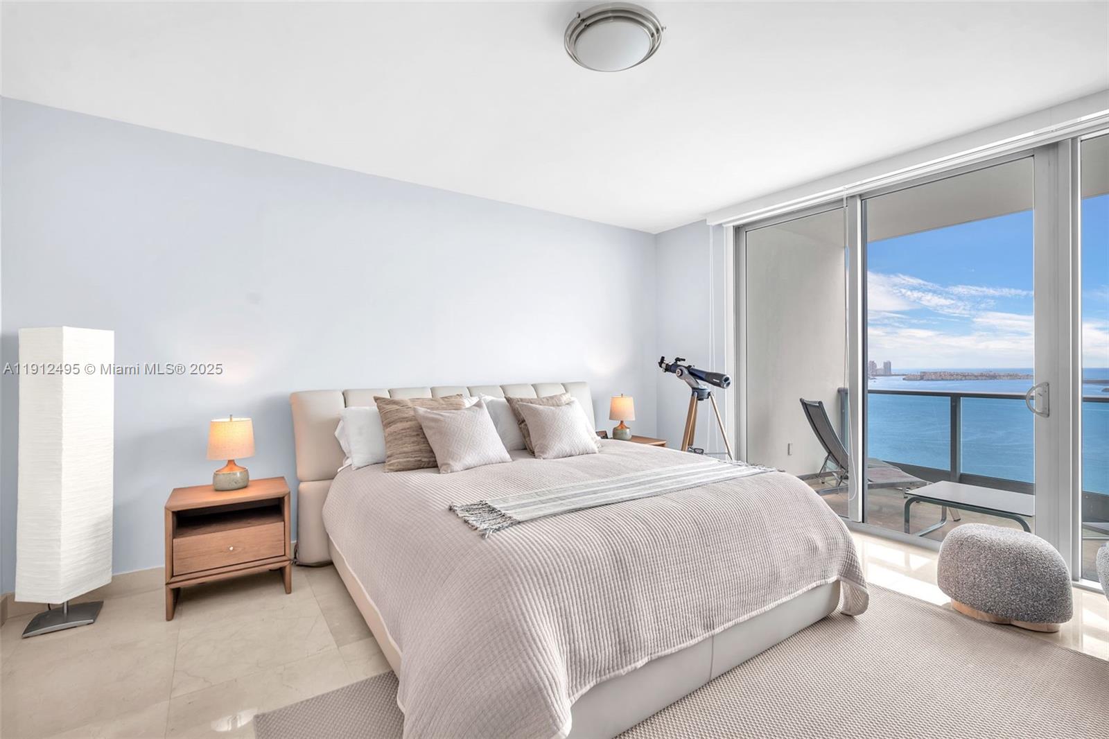 1331 Brickell Bay Drive, Unit 3609 Miami, FL 33131 - Photo 16 of 35 a bedroom with a bed and a large window