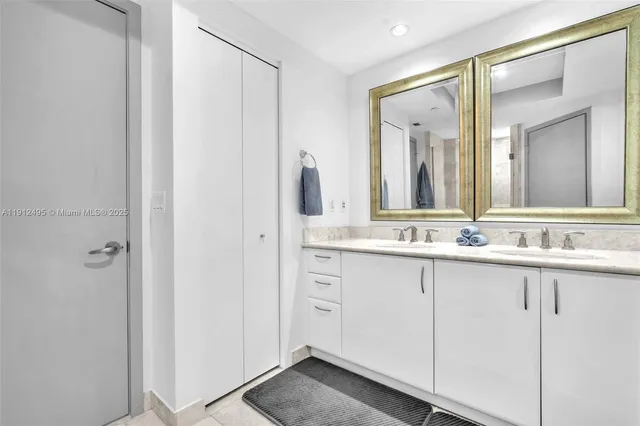 a bathroom with a double vanity sink and a mirror