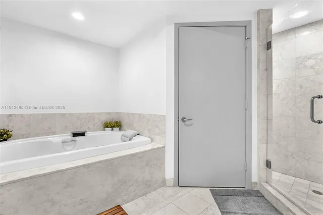 a bathroom with a tub sink and mirror