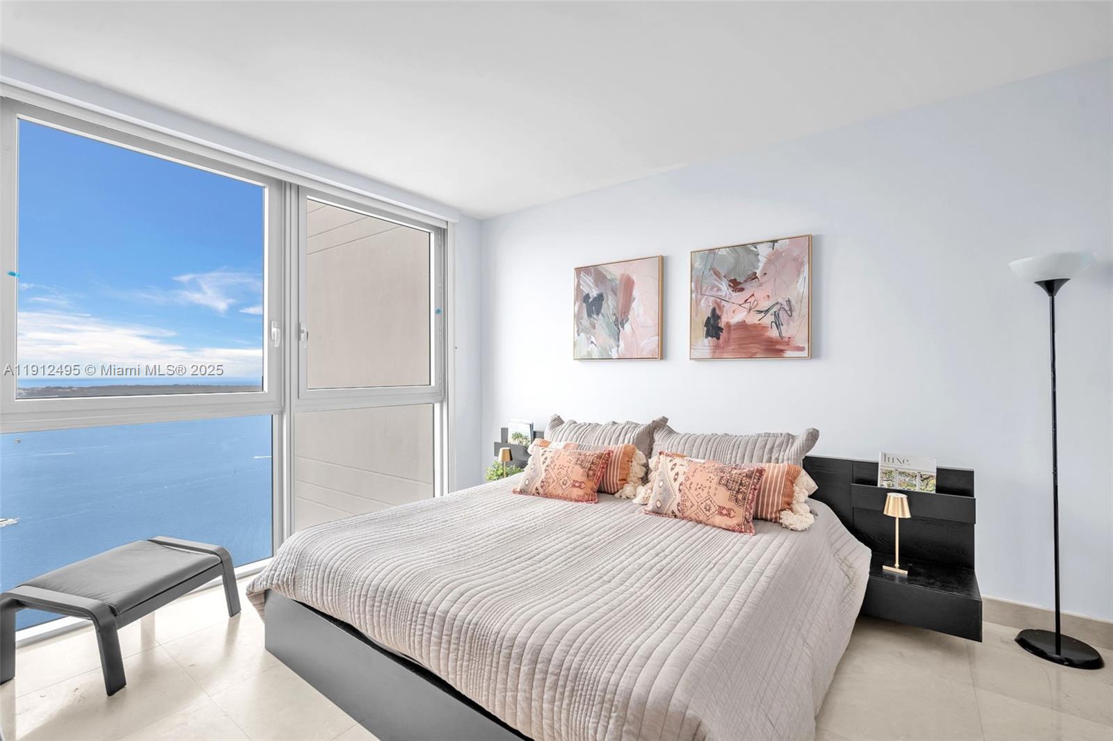 1331 Brickell Bay Drive, Unit 3609 Miami, FL 33131 - Photo 25 of 35 a bedroom with a bed and a chair