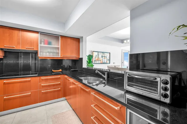a kitchen with stainless steel appliances granite countertop a sink and cabinets