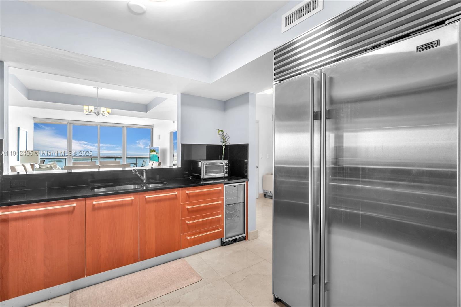 1331 Brickell Bay Drive, Unit 3609 Miami, FL 33131 - Photo 30 of 35 a kitchen with stainless steel appliances granite countertop a refrigerator and a sink