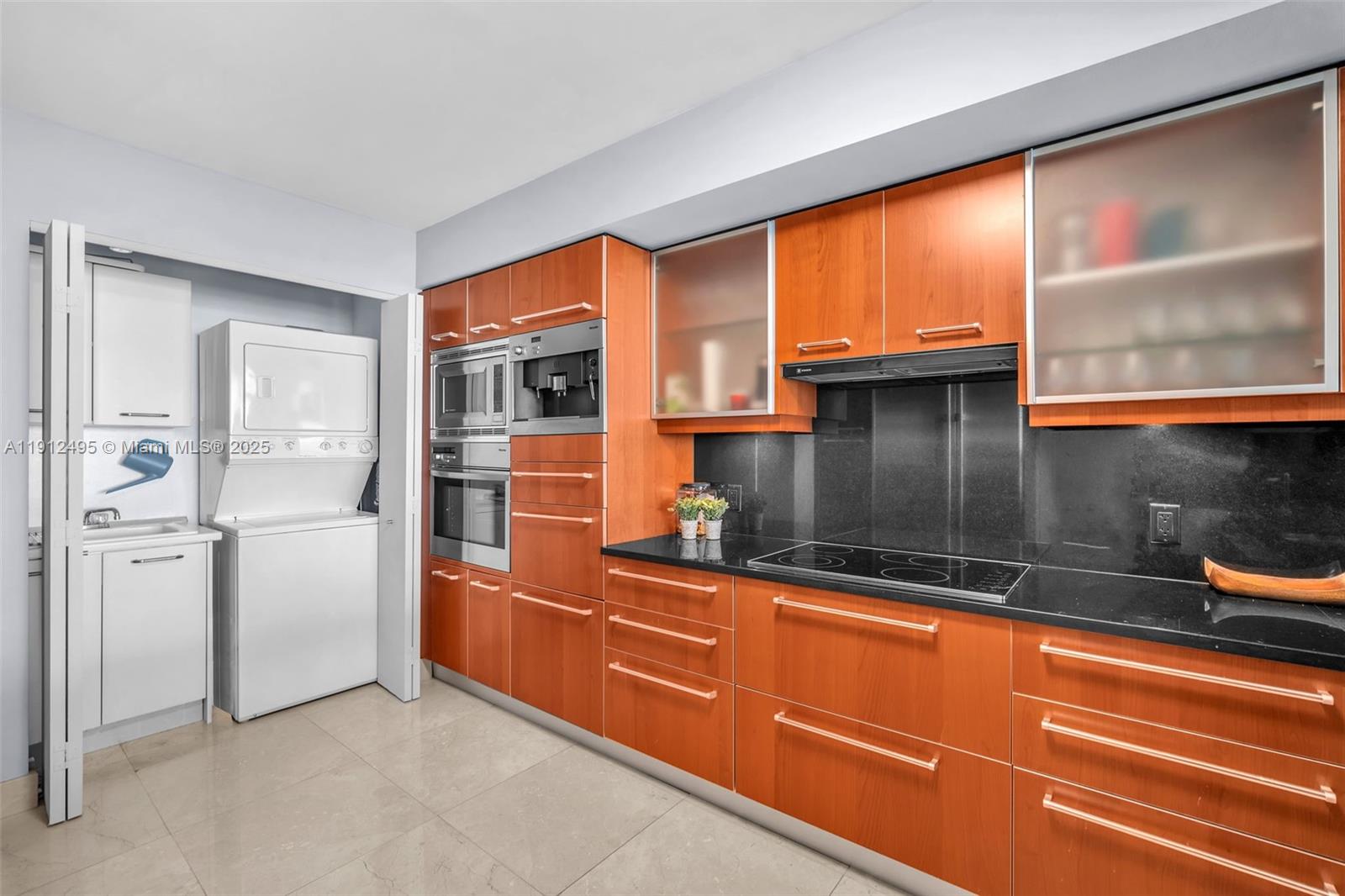 1331 Brickell Bay Drive, Unit 3609 Miami, FL 33131 - Photo 33 of 35 a kitchen with stainless steel appliances granite countertop a refrigerator and a sink