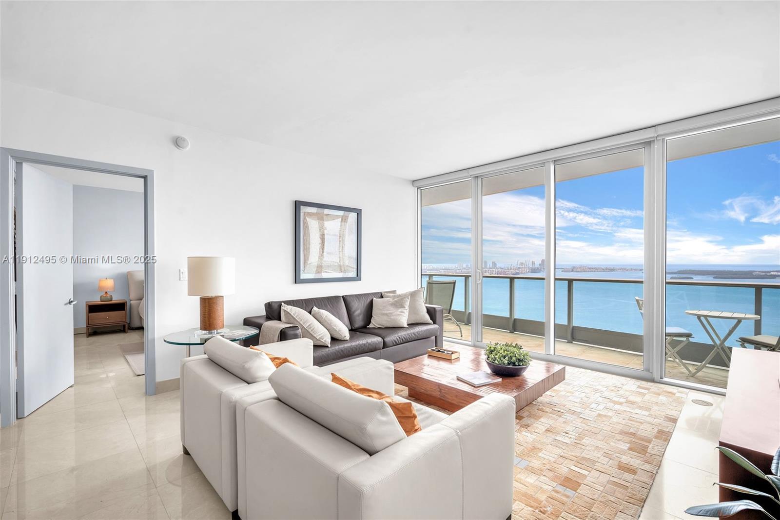 1331 Brickell Bay Drive, Unit 3609 Miami, FL 33131 - Photo 6 of 35 a living room with furniture and a large window