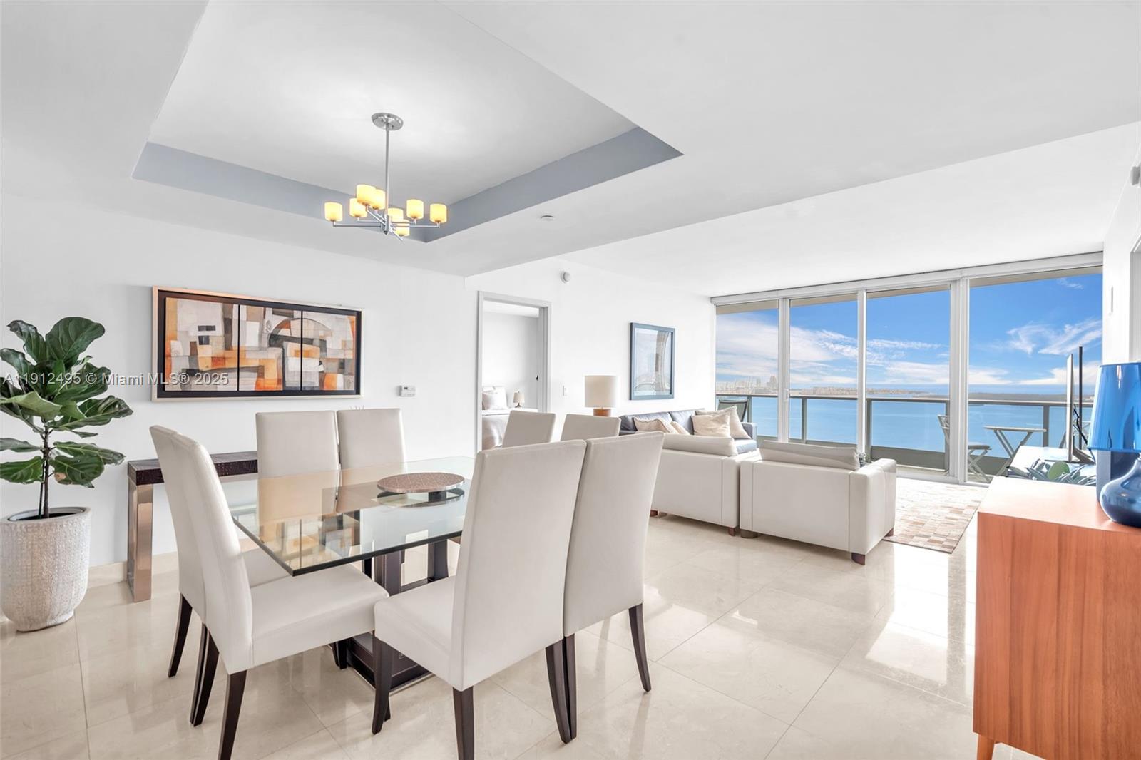 1331 Brickell Bay Drive, Unit 3609 Miami, FL 33131 - Photo 10 of 35 a dining room with furniture a kitchen and chandelier