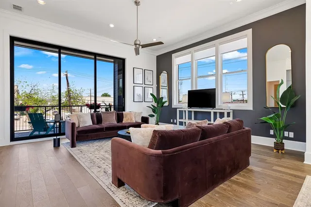 a living room with a bed furniture and a window