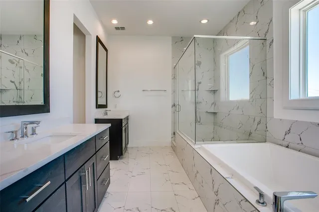 a bathroom with a tub sink and mirror