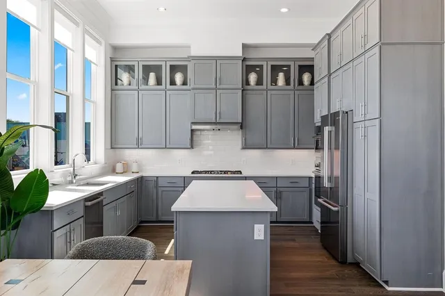a kitchen with a table chairs and a refrigerator