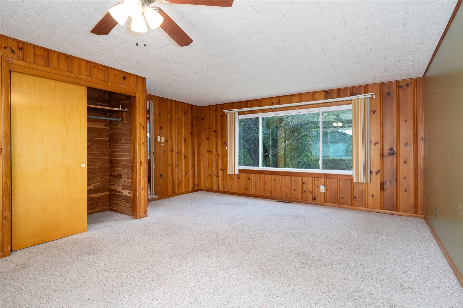 19097 1330 E Road Pontiac, IL 61764 - Photo 19 of 48 an empty room with chandelier fan and windows
