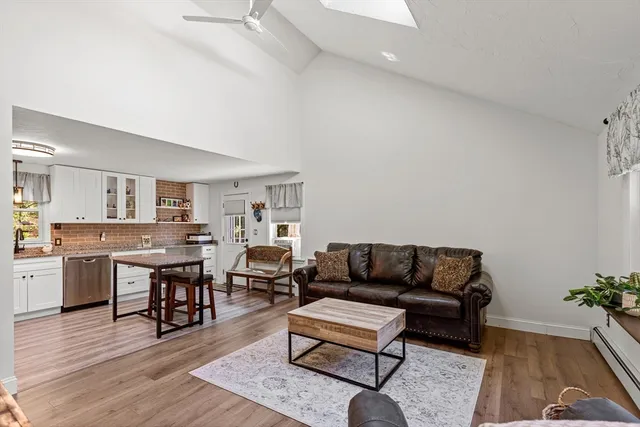 a living room with furniture kitchen view and a table