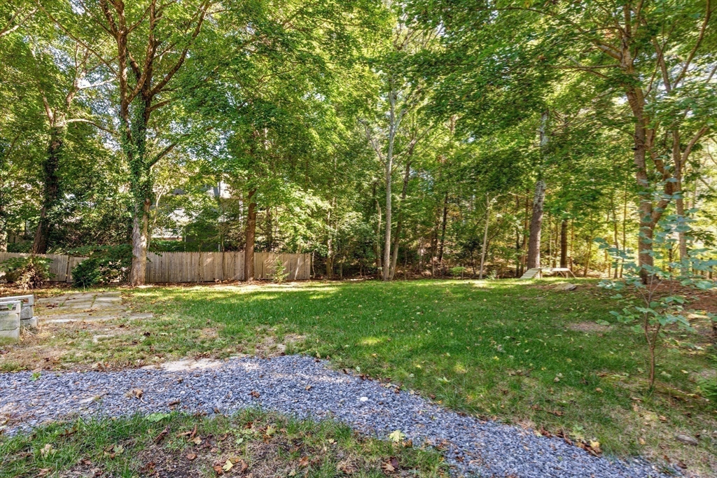901 Head Of The Bay Road Bourne, MA 02532 - Photo 17 of 20 a backyard of a house with lots of green space