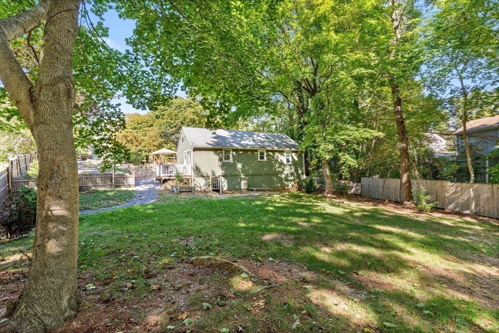 901 Head Of The Bay Road Bourne, MA 02532 - Photo 18 of 20 a view of a house with backyard and a tree