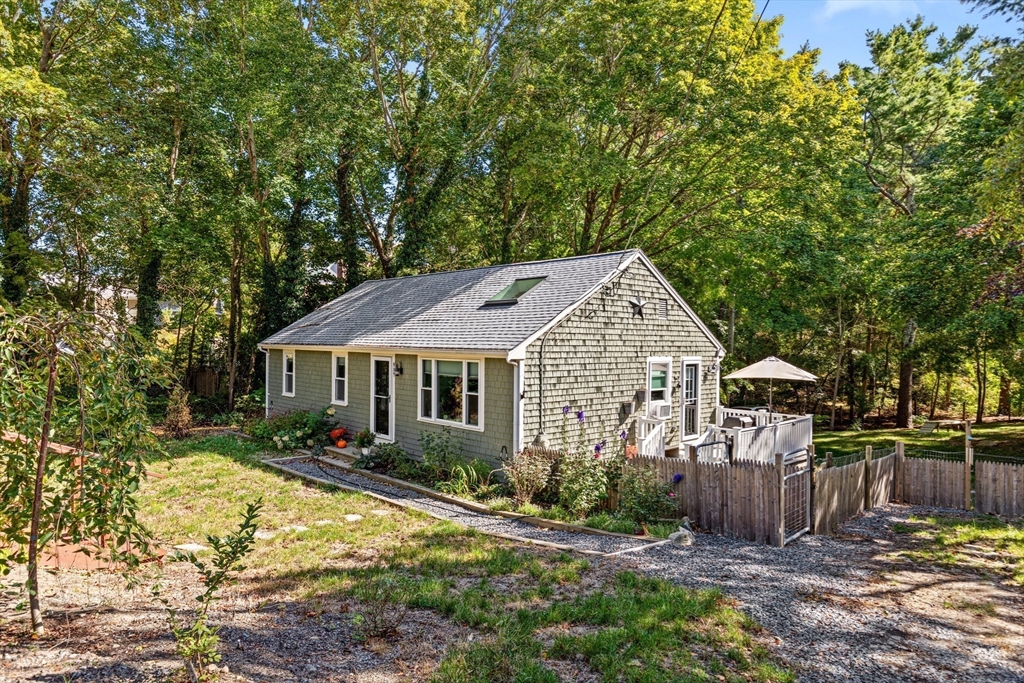 901 Head Of The Bay Road Bourne, MA 02532 - Photo 3 of 20 front view of a house with a yard