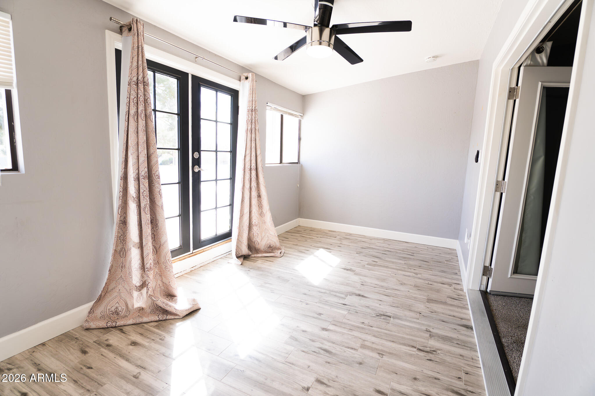 5100 North Miller Road, Unit 3 Scottsdale, AZ 85250 - Photo 16 of 31 a view of empty room with wooden floor and fan