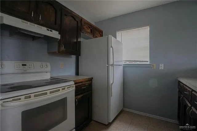 a stove top oven sitting inside of a kitchen