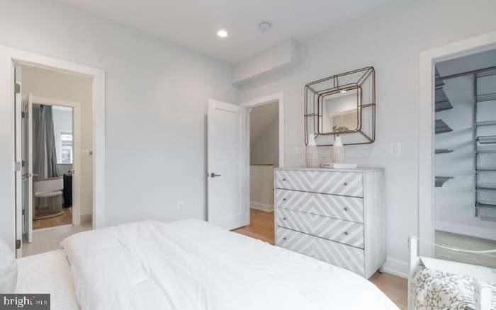 628 I Street Northeast, Unit 3 Washington, DC 20002 - Photo 17 of 32 a bedroom with a bed and a painting on the wall