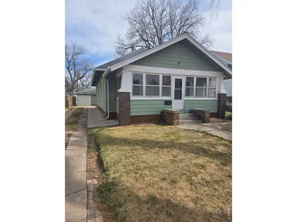 a house view with swimming pool in front of it