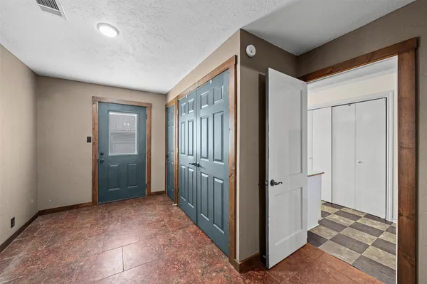 a view of a hallway with closet and wooden floor